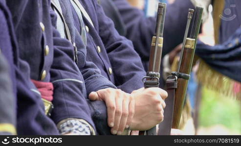 Close up of Civil War soldiers hands on guns