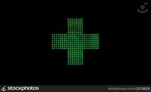 Close up of classical Pharmacy led light cross in green