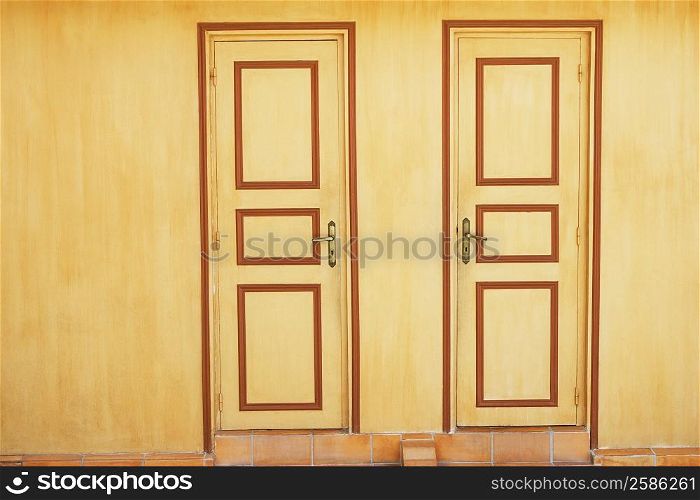 Close-up of closed doors of two houses