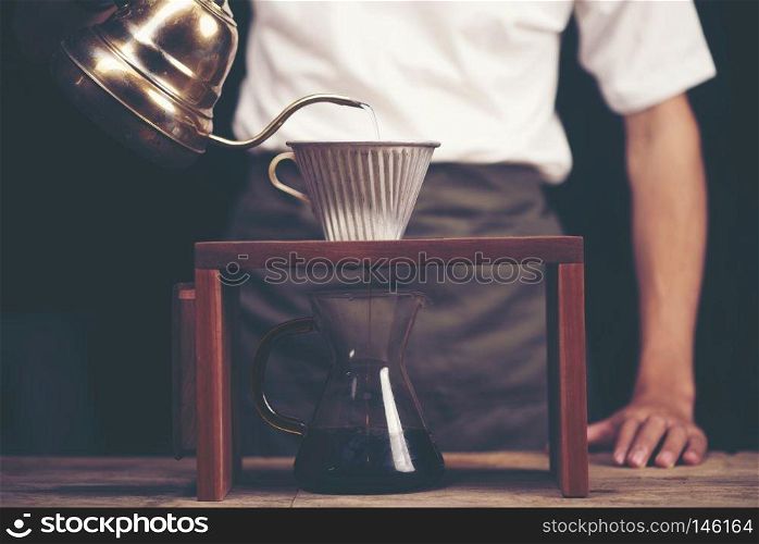Close up of coffee brewing gadgets on wooden bar counter.