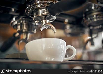 Close up of coffee machine pouring espresso in cafe, selective focus . Close up of coffee machine pouring espresso in cafe