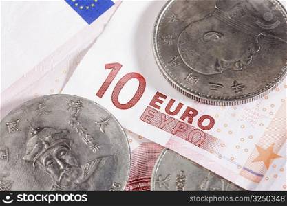 Close-up of coins and ten euro banknote
