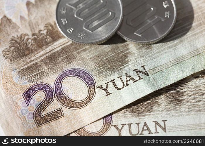 Close-up of coins on Chinese paper currency