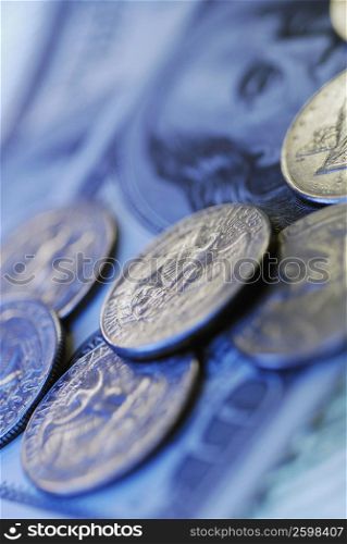 Close-up of coins on paper currency notes