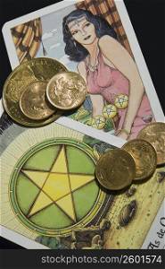 Close-up of coins on tarot cards
