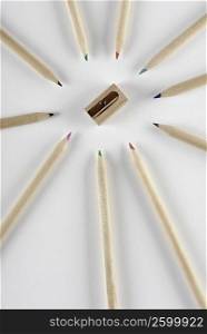 Close-up of colored pencils with a pencil sharpener