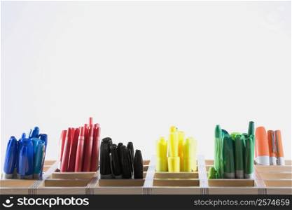 Close-up of colored pens in pen stands