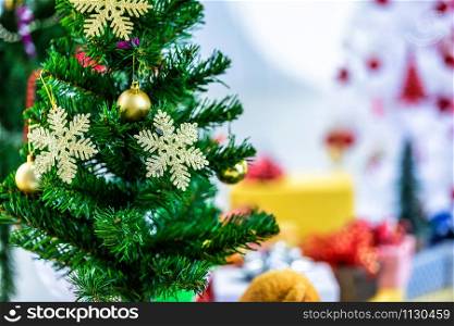 Close up of Colorful balls on Green Christmas tree with gifts background Decoration During Christmas and New Year.