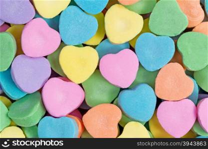 Close up of colorful heart shaped candies in filled frame format. Valentines day concept.