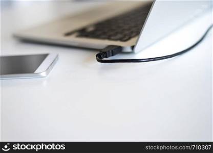 Close up of communicators device on desk, mobile phone and laptop. Rafa Fernandez