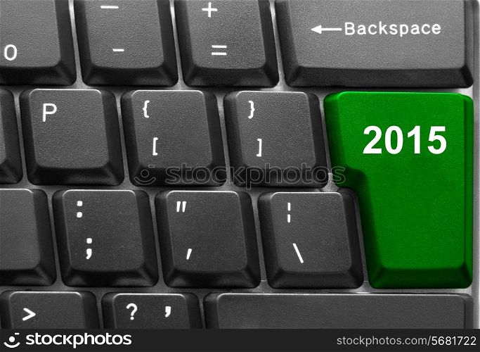 Close-up of computer keyboard with green twenty fifteen new year key