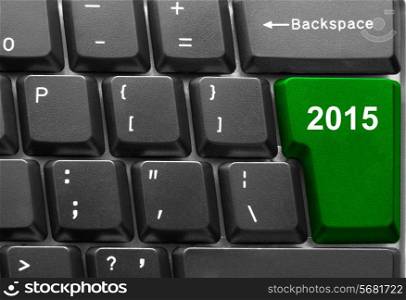 Close-up of computer keyboard with green twenty fifteen new year key
