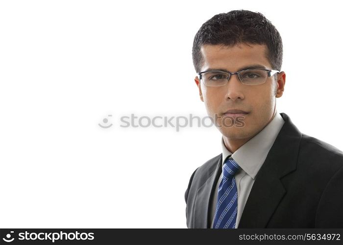 Close-up of confident businessman in glasses over white background