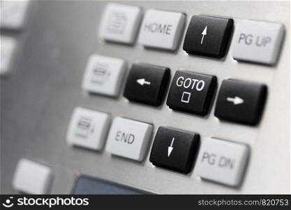 Close up of control panel keypad. Cursor keys buttons. Selective focus on GOTO key.