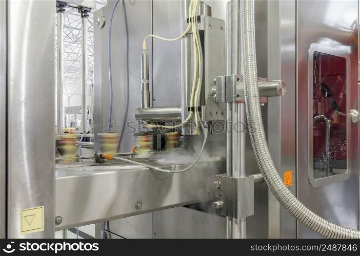 close-up of conveyor belt in motion at production and bottling of drinks in tin cans. production and bottling of drinks in tin cans. factory for bottling beverages in cans