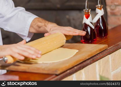 Close-up of cook hands. Close-up image of cook hands rolling out dough