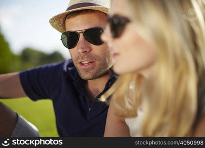 Close up of couple sitting in park