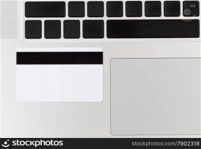 Close up of credit card on computer. Concept of fraud or phishing scheme with technology.