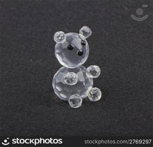 Close up of crystal bear over black background