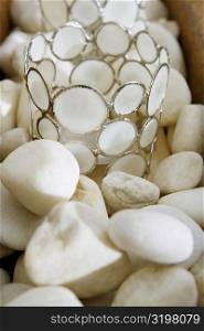 Close-up of decorative glasses on pebbles