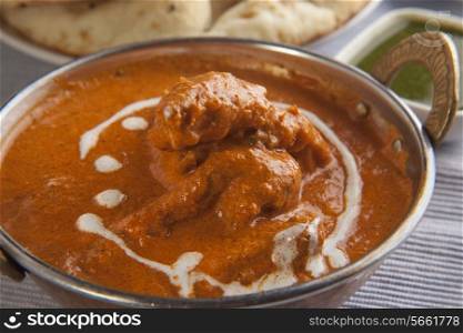 Close-up of delicious butter chicken garnished with cream