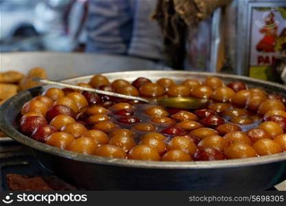 Close-up of delicious gulab jamun on display in stall