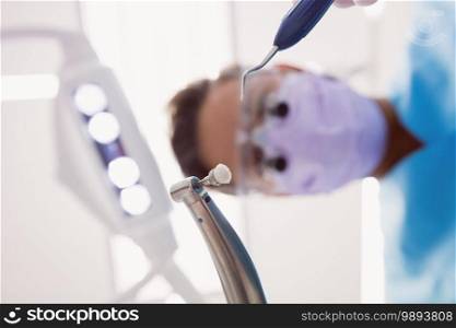 Close-up of dentist holding dental tools at dental clinic