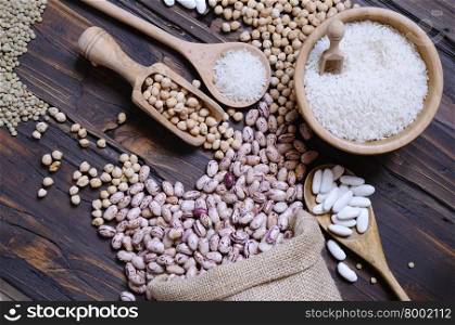 Close-up of different cereals on wooden table. From above