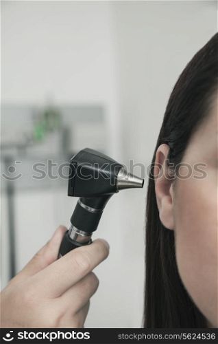 Close-Up of doctor checking the ears of a patient