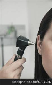 Close-Up of doctor checking the ears of a patient