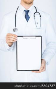 close up of doctor holding blank white paper