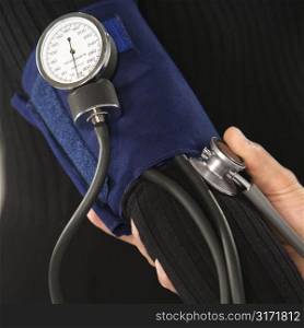 Close up of doctor testing blood pressure of patient.