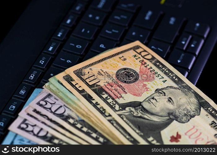Close up of dollars money on keyboard isolated.