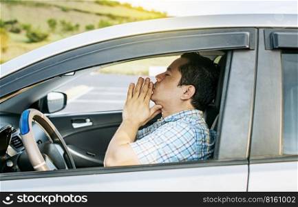 Close up of driver praying in his vehicle, Driver male praying in his vehicle before leaving. Concept of driver man meditating with his hands together