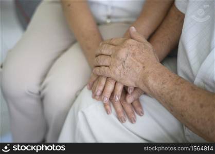 Close up of elderly hands holding each other , Grandfather hands is holding grandma hands , together , family concept .. Close up of elderly hands holding each other , Grandfather hands is holding grandma hands , together , family concept