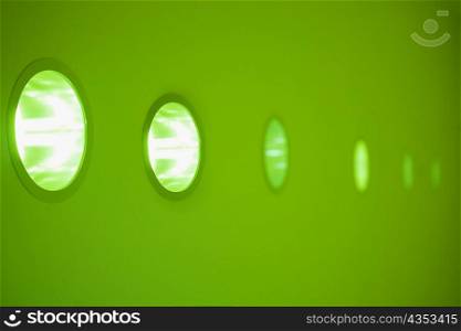 Close-up of electric lights on a wall in a row