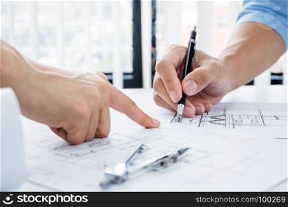 Close up of engineer hands discussing a building construction project at workplace