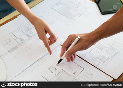 Close up of engineer hands discussing a building construction project at workplace