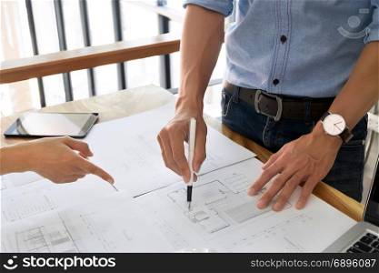 Close up of engineer hands discussing a building construction project at workplace