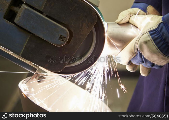 Close Up Of Engineer Using Grinding Machine In Factory