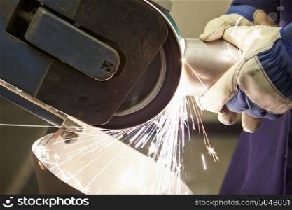 Close Up Of Engineer Using Grinding Machine In Factory