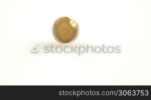 close up of euro coin spinning on white surface