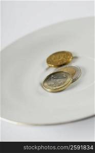 Close-up of European Union coins in a plate