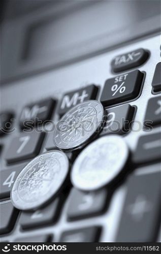 Close-up of European union coins on a calculator