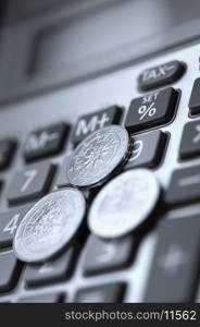 Close-up of European union coins on a calculator