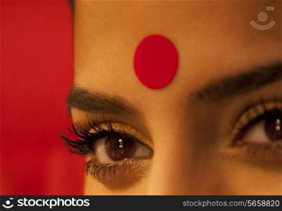 Close-up of eye and bindi of a woman