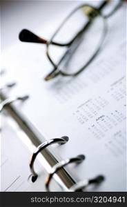 Close-up of eyeglasses on a personal organizer