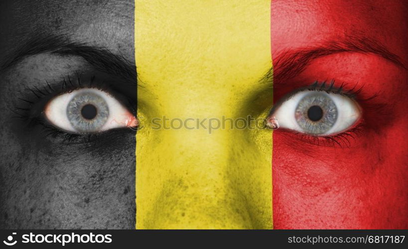 Close up of eyes. Painted face with flag of Belgium