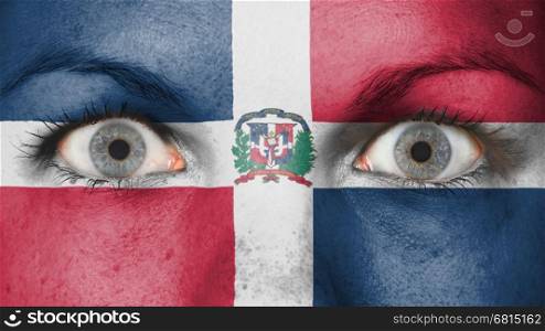 Close up of eyes. Painted face with flag of Dominican Republic