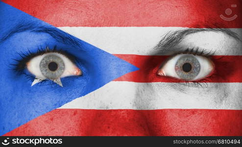 Close up of eyes. Painted face with flag of Puerto Rico